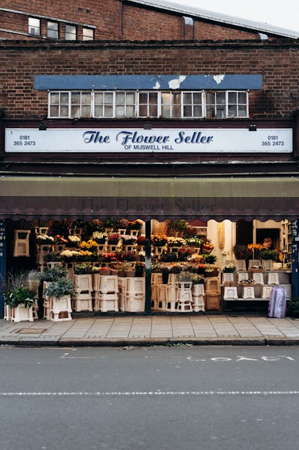 The exterior of The Flower Seller of Muswell Hill, a floral shop located on London Road Morden, showcasing a variety of fresh flowers and floral arrangements. The display features colorful bouquets of